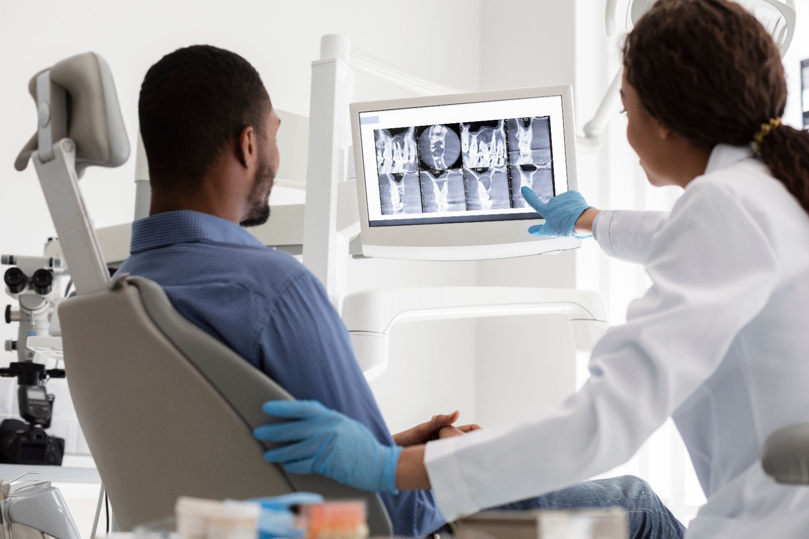 Consultant reviewing DXA bone density scan for osteoporosis risk assessment
