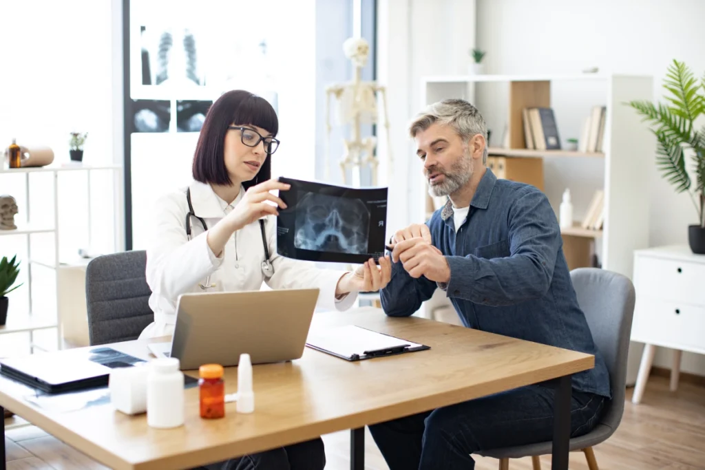 Consultant discussing integrated bone health and wellbeing with patient at London Osteoporosis Clinic